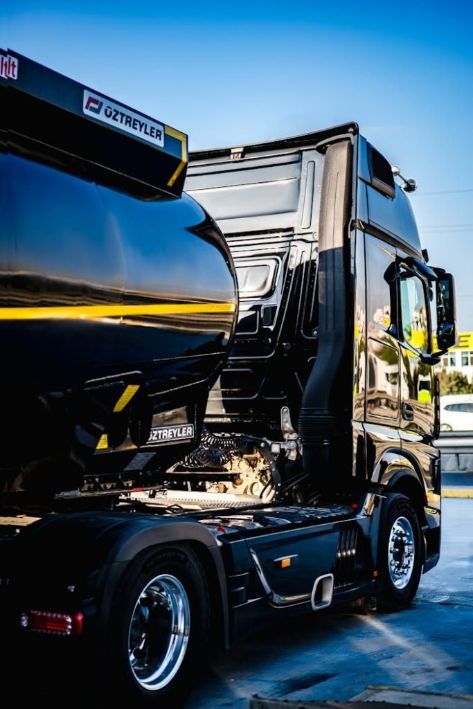 black-truck-16100083 Black semi truck ready for cargo loading at an industrial dock.